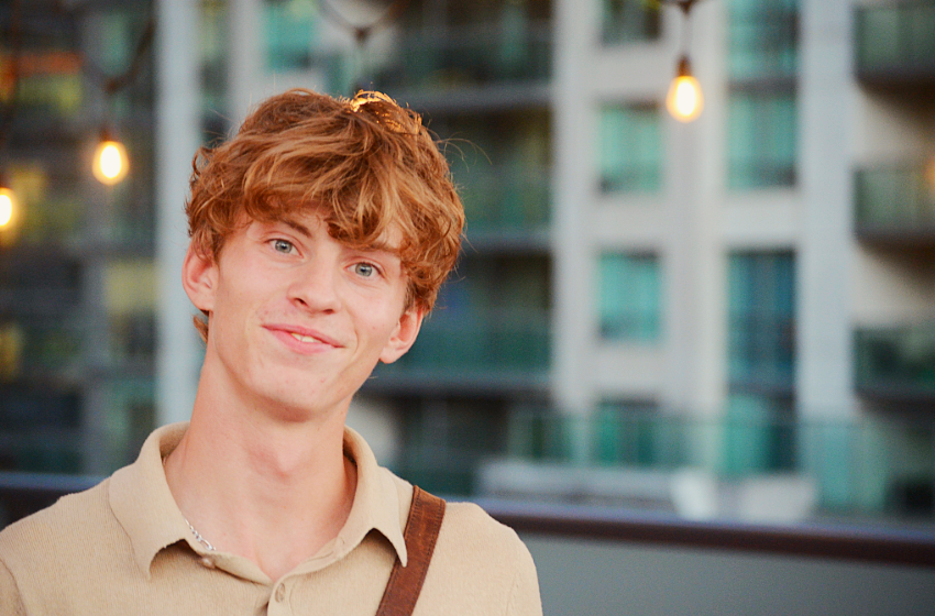 A blonde-haired man smiling at the camera.