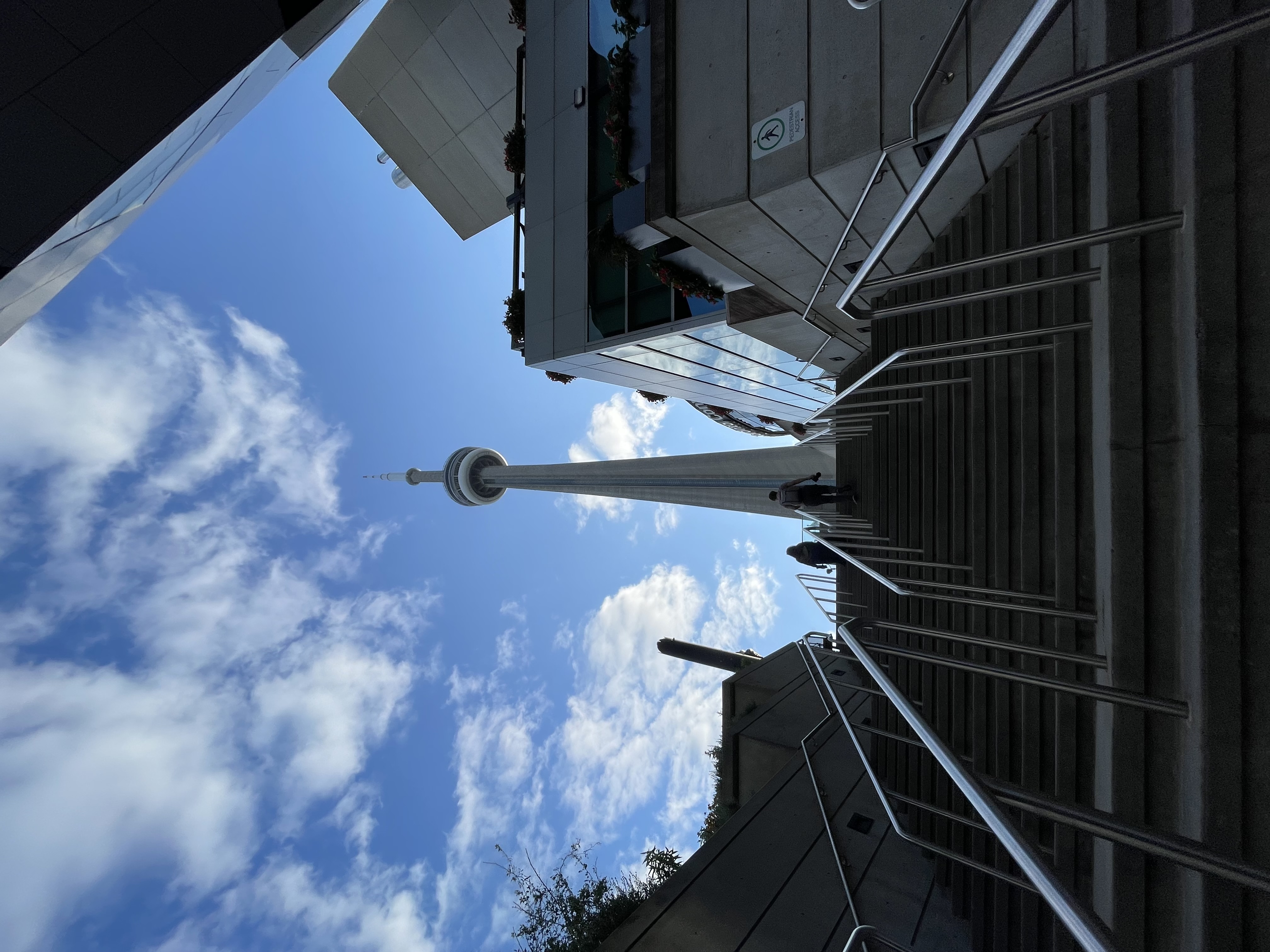 Image of the CN Tower from below a tall flight of stairs.