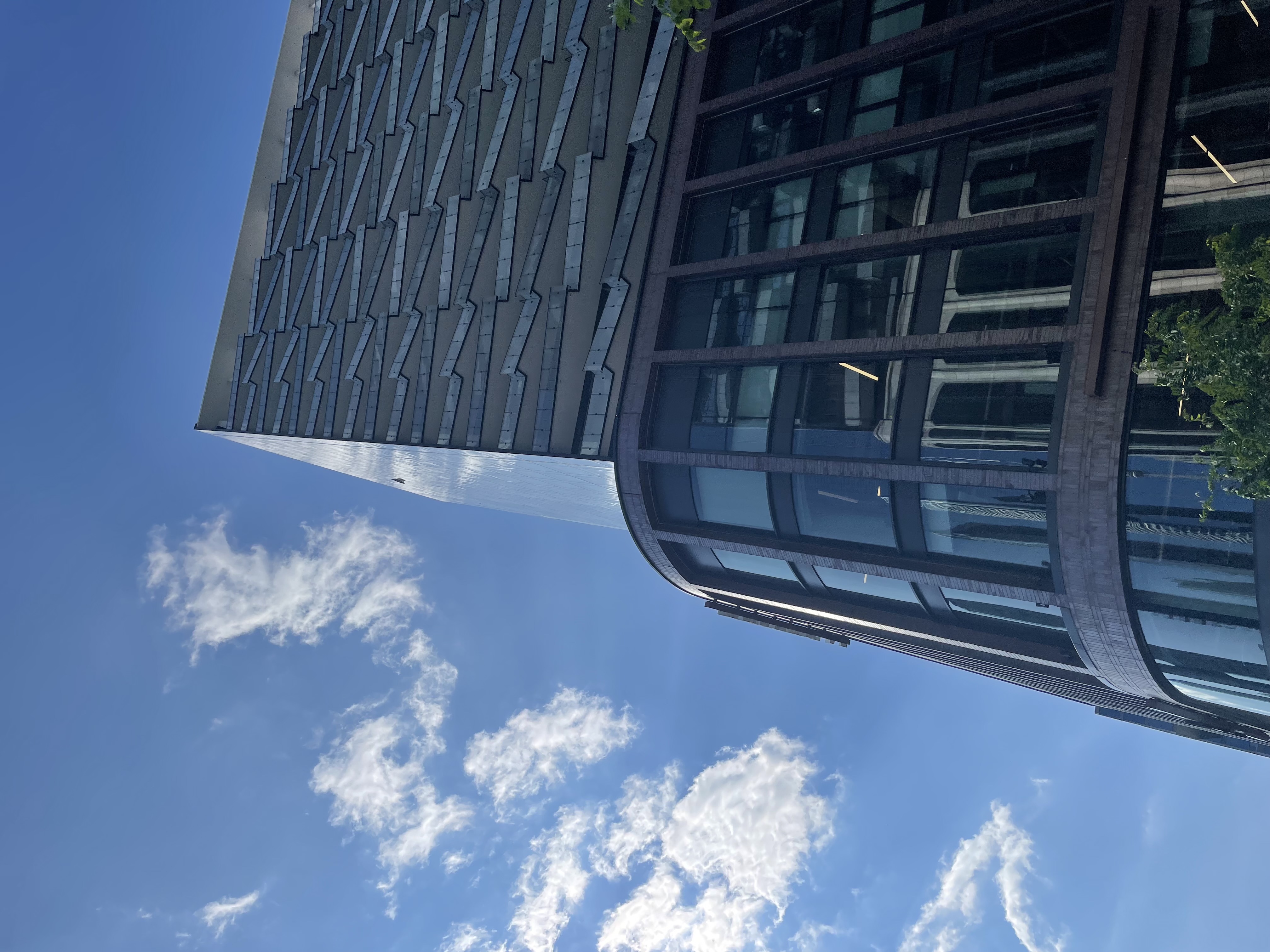 A tall glass building in Toronto on a sunny day.